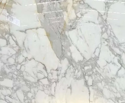 white stone slab, with fine veining and a reflective finish, in a close surface view