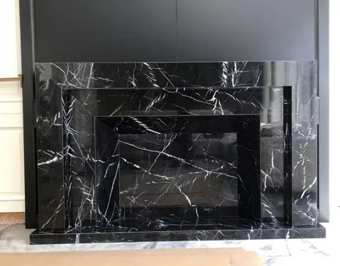 White Volakas marble fireplace surround, with bold veining and strong pattern contrast