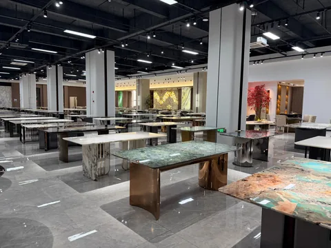 green stone dining table, with twin supporting bases and cloudy mottling, in a showroom