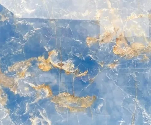 blue stone slab, with cloudy mottling and a reflective finish, in a close surface view