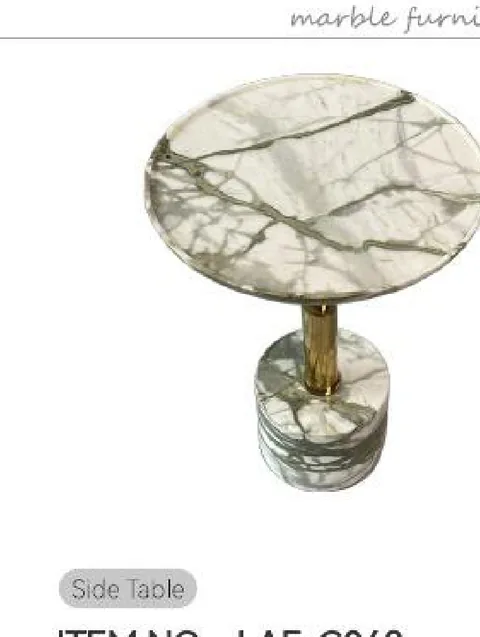white stone side table, with a round top and bold veining, on a plain backdrop
