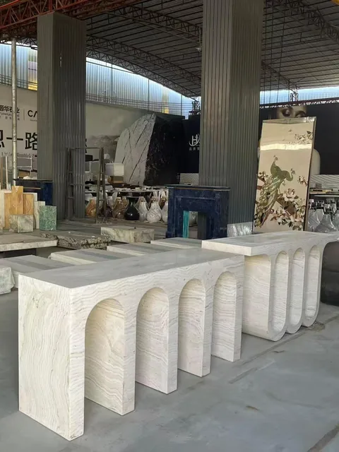 white stone console table, with fine veining, in a workshop