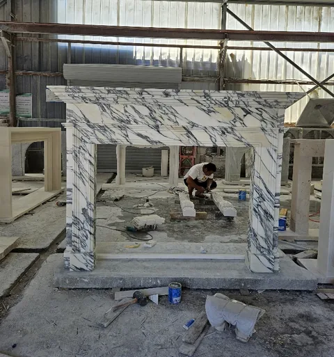 White Volakas marble fireplace surround, with bold veining, shown from a frontal view with broad sweeping markings