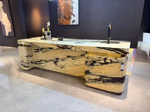 gold stone countertop, with bold veining and a reflective finish, in a showroom