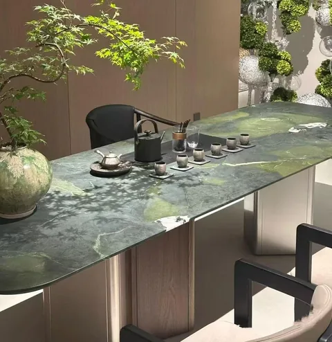 green stone dining table, with cloudy mottling and a reflective finish, near warm woodwork