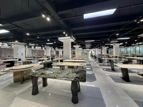 green stone dining table, with a rectangular top and cloudy mottling, in a showroom