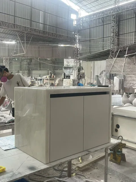 cream-beige stone vanity, with a freestanding cabinet and fine veining, in a workshop