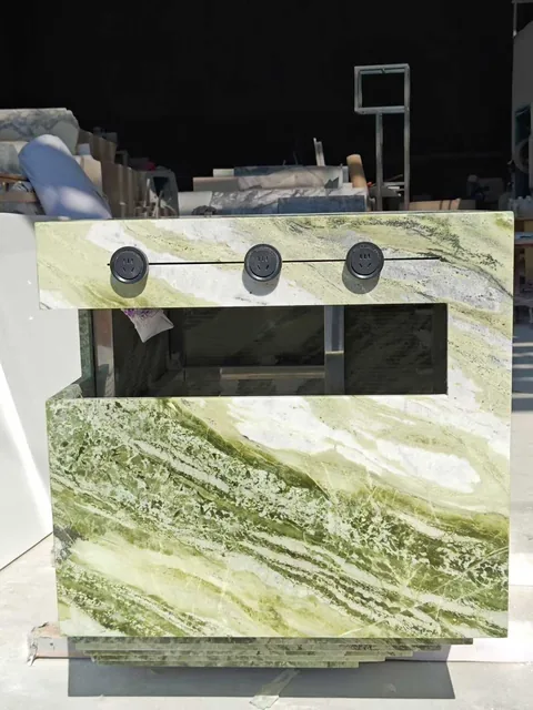 green stone countertop, with bold veining and a reflective finish, in a workshop