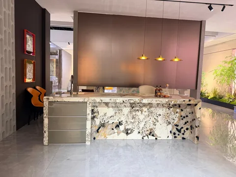white stone countertop, with a waterfall edge and angular breccia fragments, in a showroom
