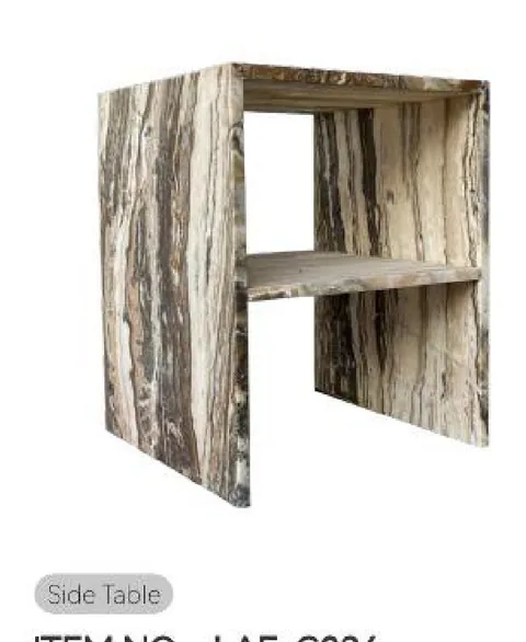 cream-beige stone side table, with bold veining, on a plain backdrop