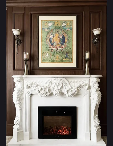 White Volakas marble fireplace surround, with fine veining, shown from a frontal view with room decor nearby