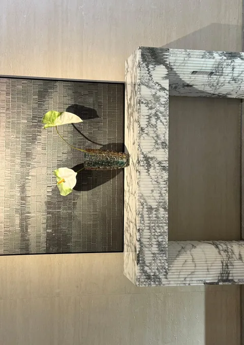 white stone console table, with fine veining, in a furnished room