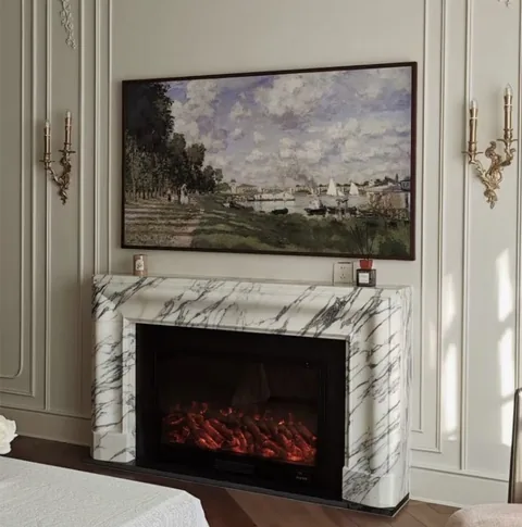 Arabescato Corchia marble fireplace surround, with bold veining and a reflective finish, in a furnished room