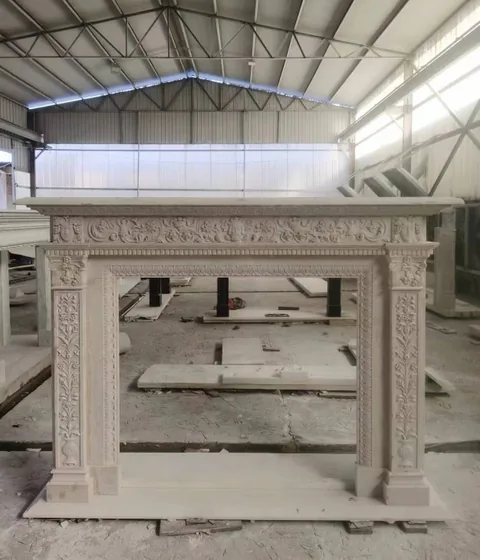 White Volakas marble fireplace surround, with carved scrollwork and a plain surface, in a workshop