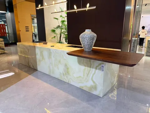 white stone countertop, with banded onyx-like striping and a reflective finish, in a showroom