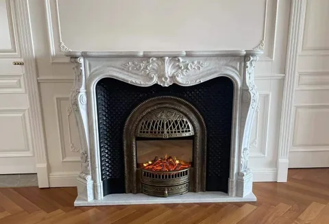 White Volakas marble fireplace surround, showing a single main form with an uncluttered setting