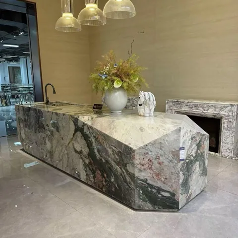 gray stone countertop, with a waterfall edge and bold veining, in a showroom