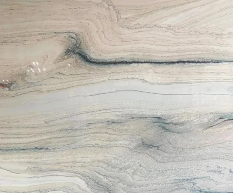 cream-beige stone slab, with banded onyx-like striping and a reflective finish, in a close surface view