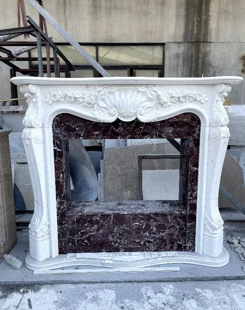 White Volakas marble fireplace surround, with bold veining, shown from a frontal view with workshop equipment nearby