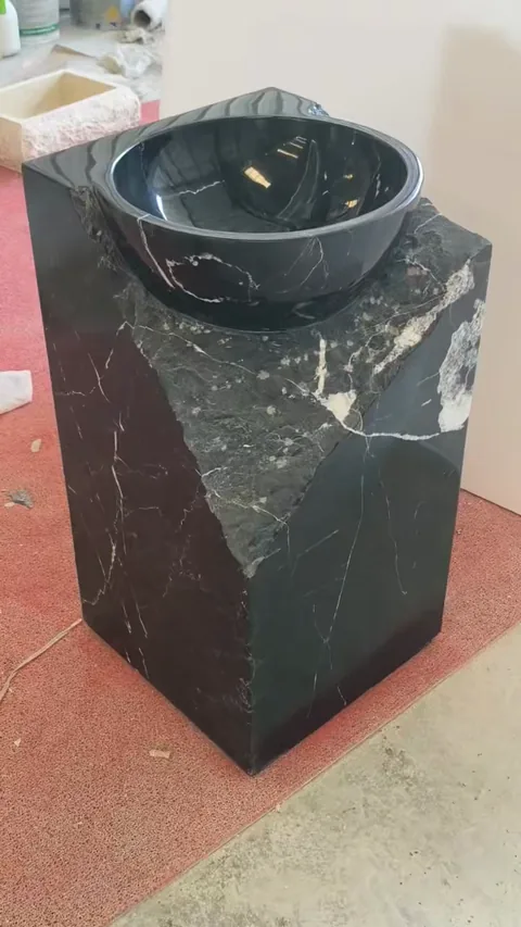 black stone sink, with fine veining and a reflective finish, in a workshop