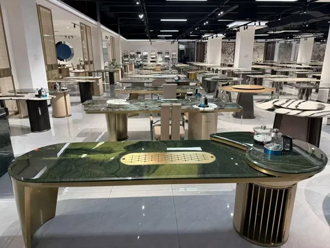 green stone dining table, with twin supporting bases and cloudy mottling, in a showroom