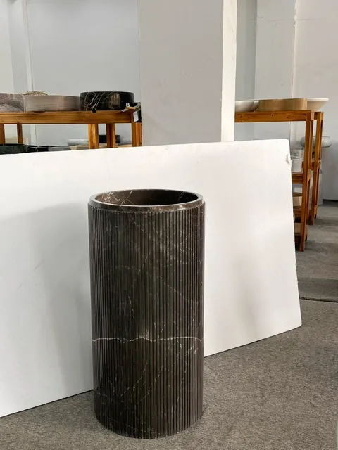 black stone sink, with fine veining and a reflective finish, in a showroom