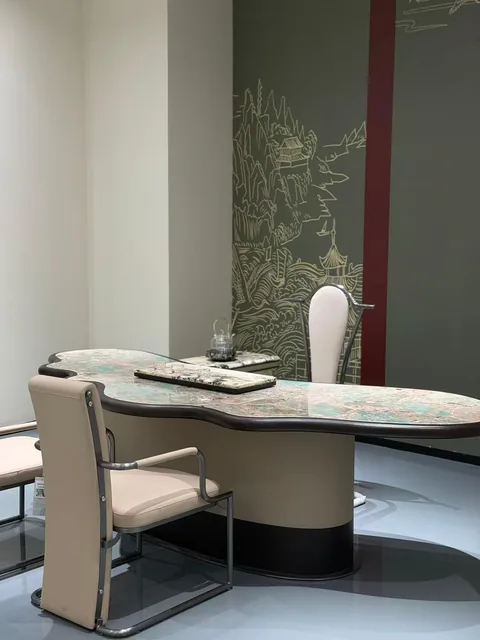 cream-beige stone dining table, with an irregular organic edge and cloudy mottling, in a showroom