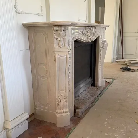 White Volakas marble fireplace surround, with a plain surface, in a workshop
