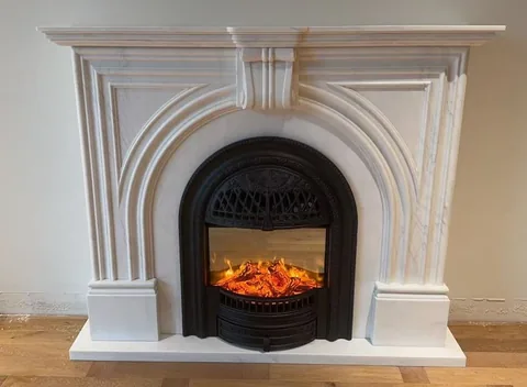 White Volakas marble fireplace surround, with fine veining and closely spaced markings and subtle pattern contrast
