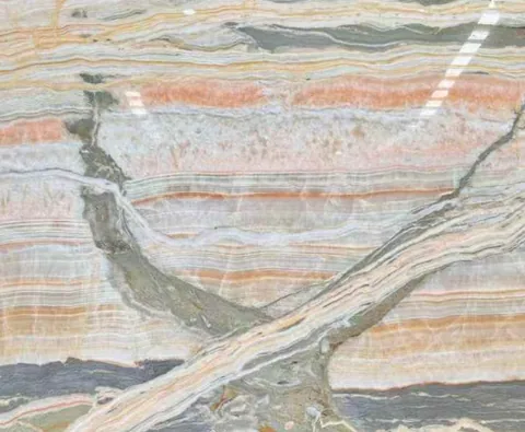 cream-beige stone slab, with banded onyx-like striping and a reflective finish, in a close surface view