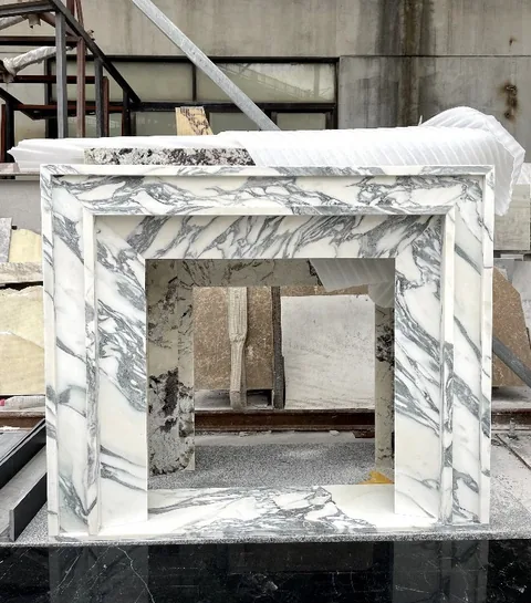 white stone side table, with bold veining and a reflective finish, in a workshop