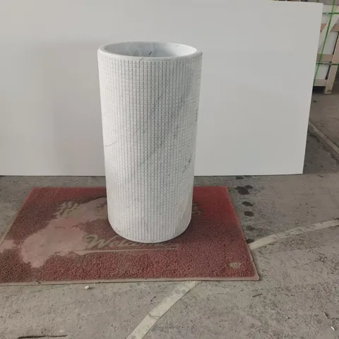 white stone landscape feature, with a stone planter and fine veining, in a workshop