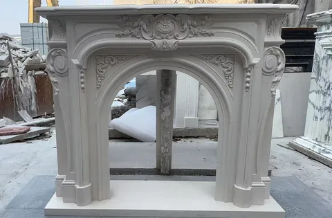 White Volakas marble fireplace surround, with workshop equipment nearby