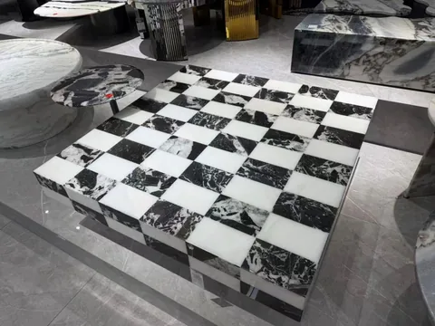 multicolored stone coffee table, with bold veining and a reflective finish, in a showroom