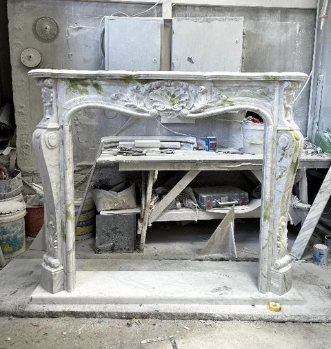 White Volakas marble fireplace surround, with fine veining, showing a single main form with subtle pattern contrast