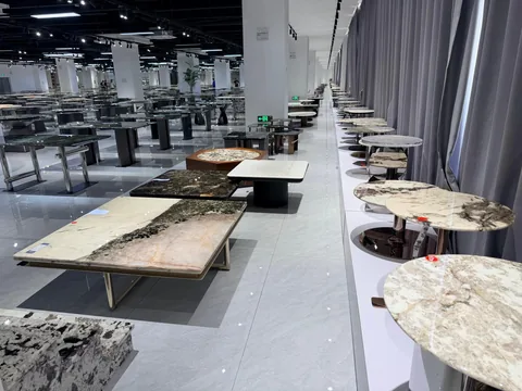 cream-beige stone coffee table, with a rectangular top and bold veining, in a showroom