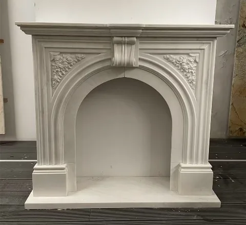 White Volakas marble fireplace surround, with fine veining, showing a single main form with subtle pattern contrast