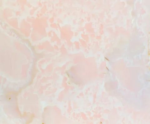 rose-red stone slab, with a single full slab and cloudy mottling, in a close surface view