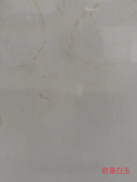 white engineered stone slab, with a single full slab and fine veining, in a close surface view