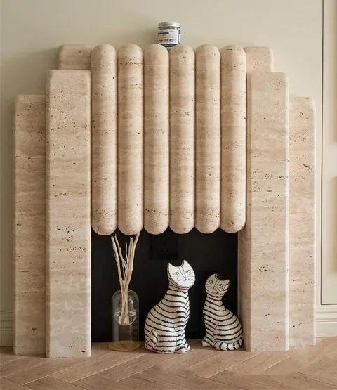 travertine fireplace surround, with stepped tiers and linear travertine grain, in a furnished room