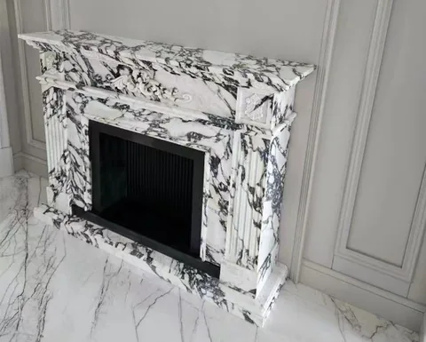 Arabescato Corchia marble fireplace surround, with bold veining and a reflective finish, in a furnished room