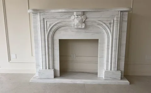 White Volakas marble fireplace surround, with fine veining, shown from a frontal view