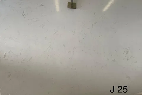 white engineered stone slab, with a single full slab and fine veining, in a close surface view