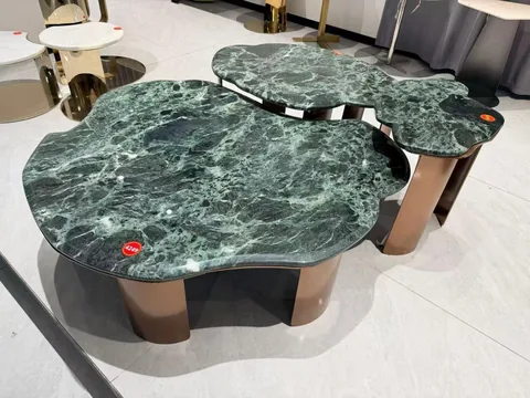 green stone coffee table, with twin supporting bases and cloudy mottling, in a showroom