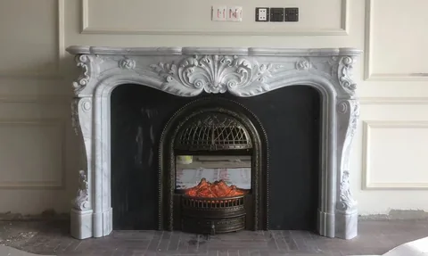 White Volakas marble fireplace surround, with fine veining, shown from a frontal view with single main form