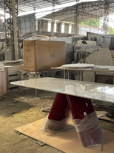 cream-beige stone countertop, with a single-level island and fine veining, in a workshop