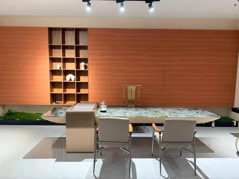 green stone dining table, with a crystalline texture and a reflective finish, in a showroom