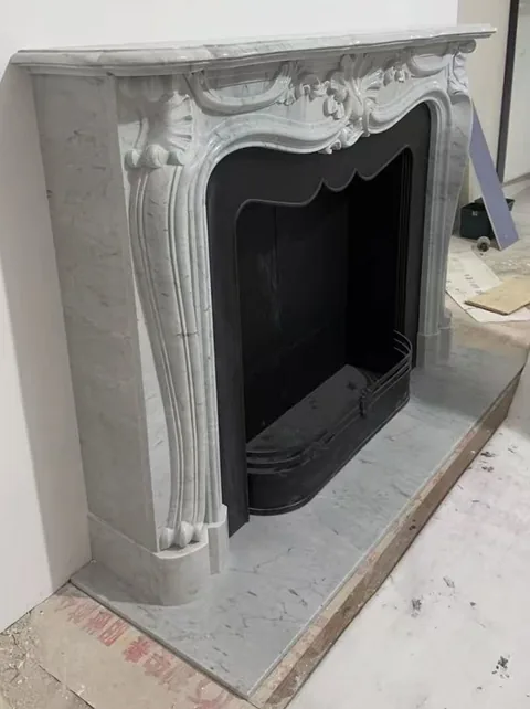 White Volakas marble fireplace surround, with fine veining and subtle pattern contrast