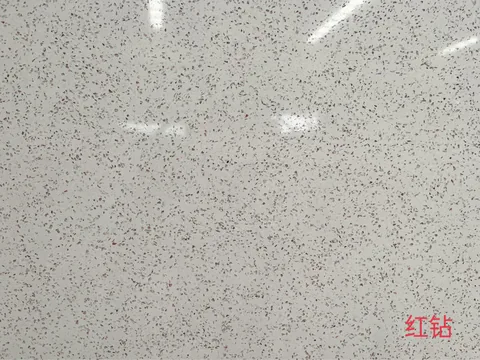 white engineered stone slab, with a single full slab and a speckled texture, in a close surface view