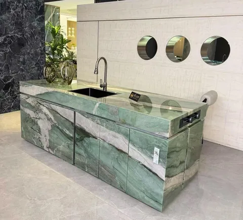 green stone countertop, with bold veining and a reflective finish, in a showroom